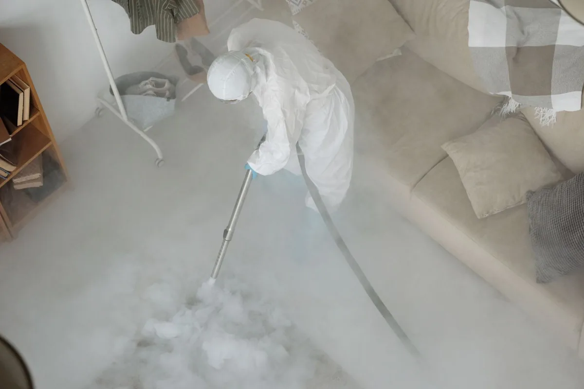 Biohazard cleanup technician in protective equipment, Saylorville, IA
